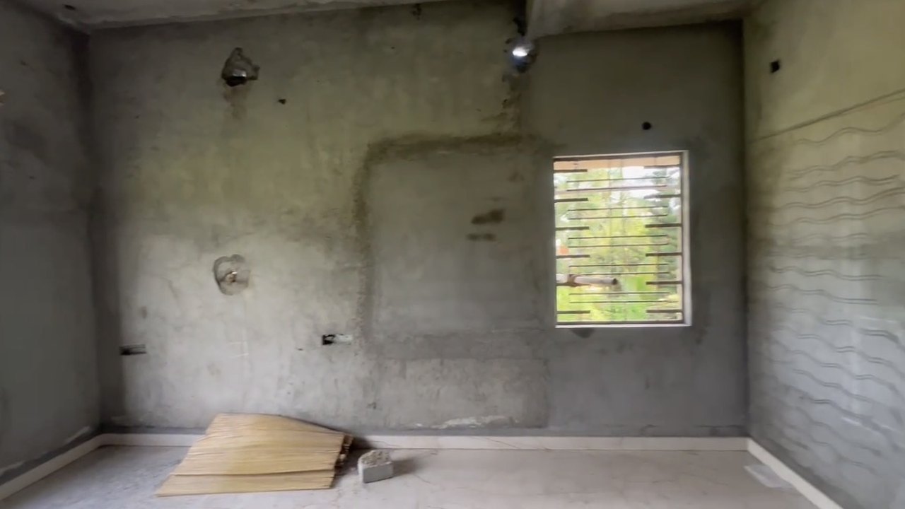 Bare concrete room before redesign
