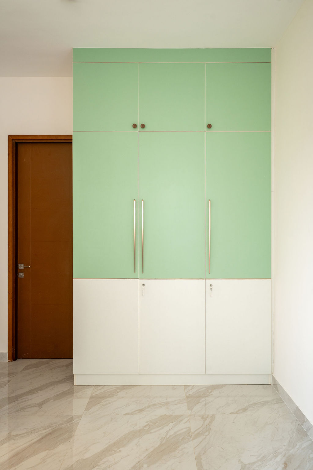 Pista-green and white wardrobe with slim brass handles