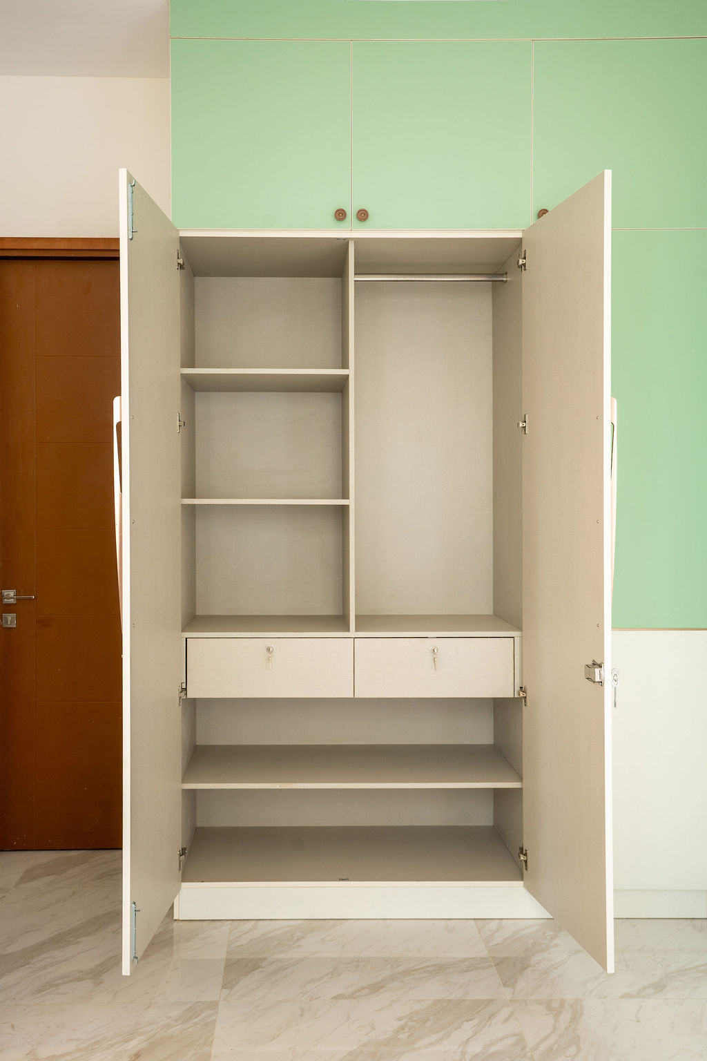 Open wardrobe showing shelves, drawers and hanging rail