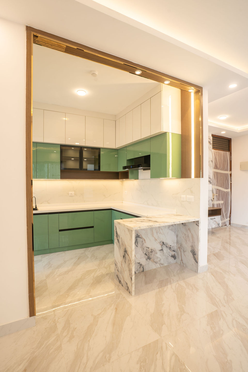 View into the green kitchen through a brass-edged opening