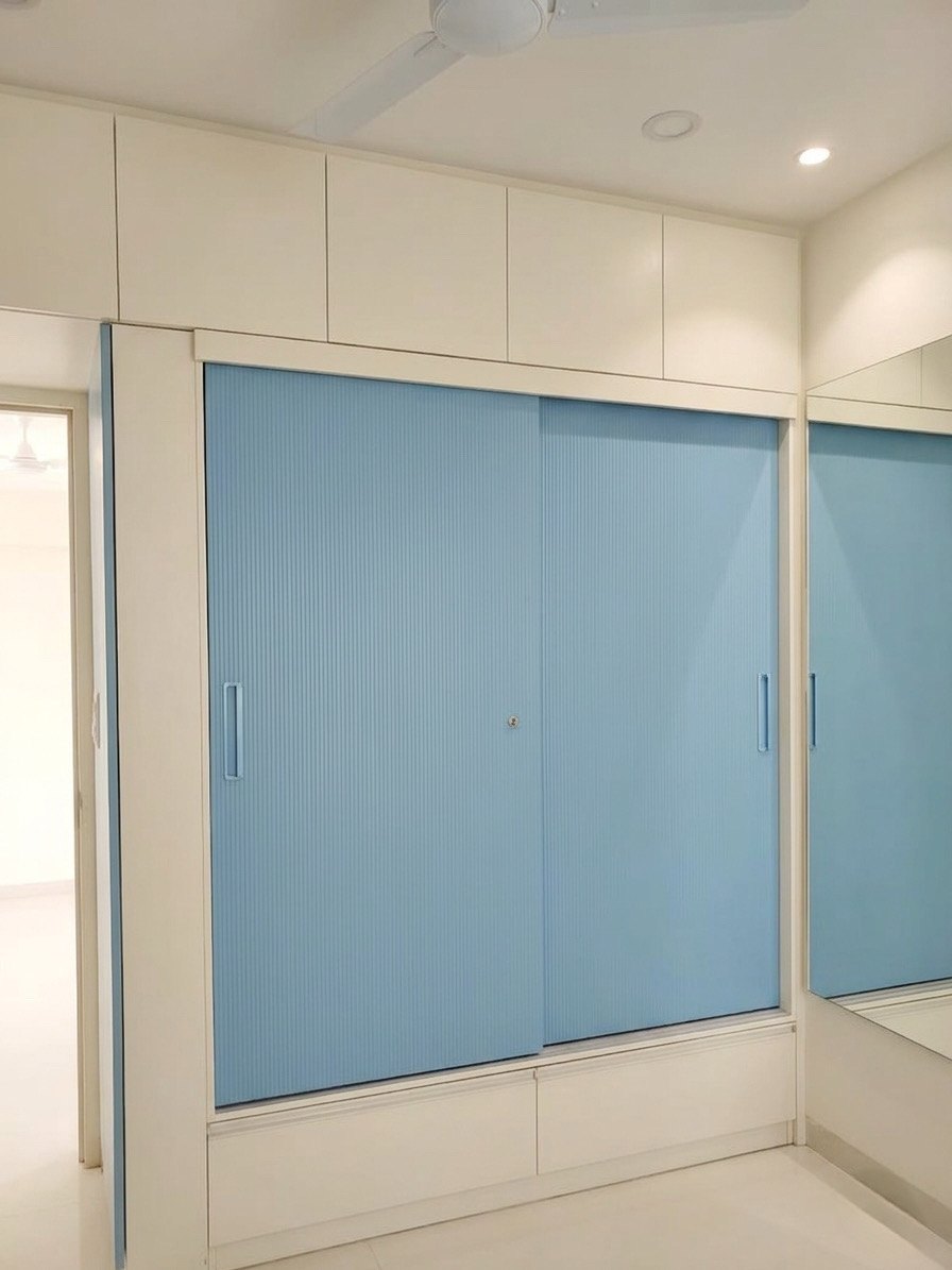 Powder-blue sliding-door wardrobe with mirror panel