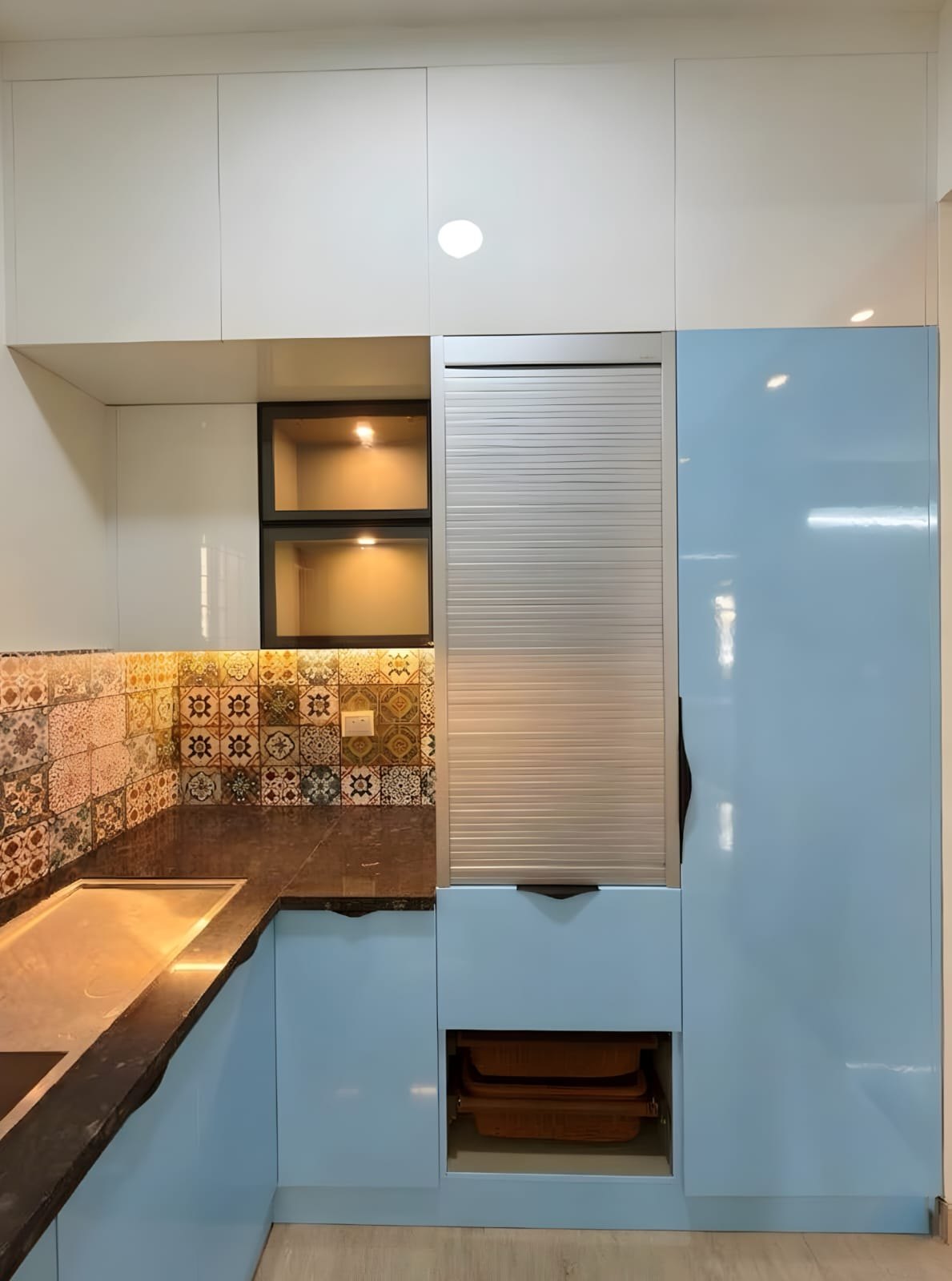 Blue kitchen tall unit with aluminium roller shutter and basket drawers