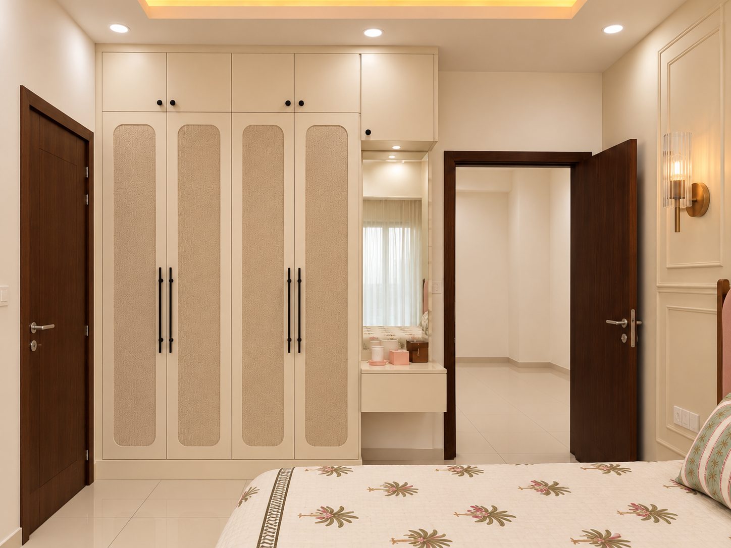 Cream wardrobe with cane-textured arched door panels, black bar handles and built-in dressing nook, Sarjapur Road 2 BHK