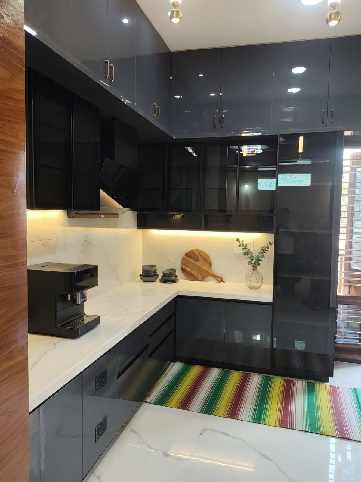 Charcoal high-gloss L-shaped kitchen with white marble counters