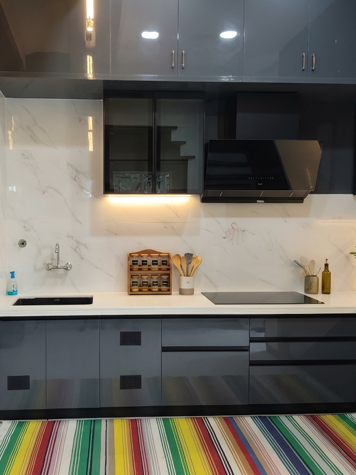 Grey kitchen run with sink, induction hob and black chimney