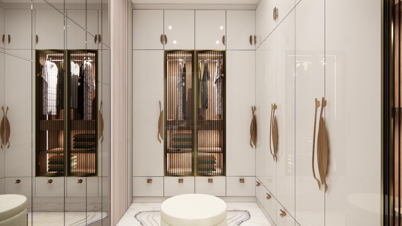 Glossy white walk-in wardrobe with fluted-glass display and stool