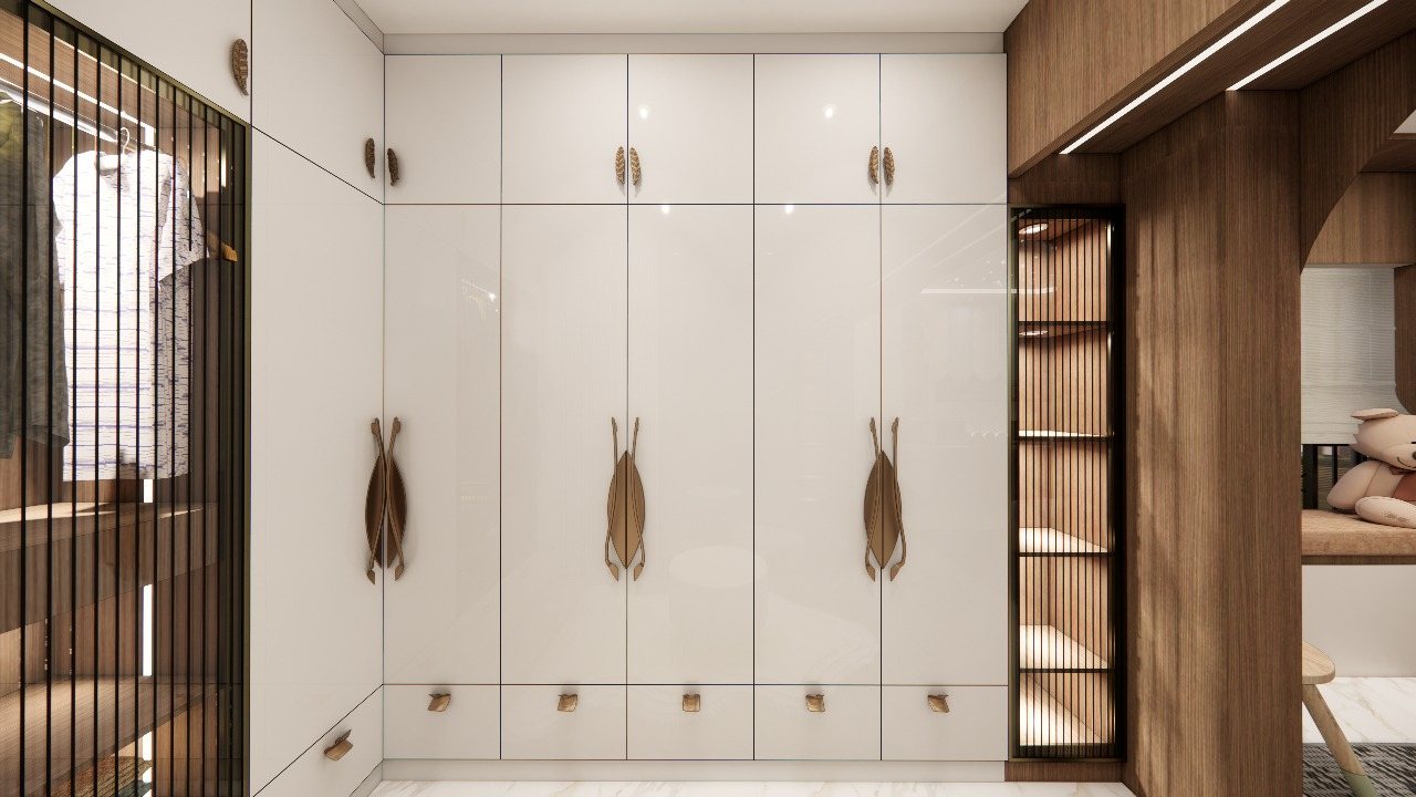 White wardrobe wall with leaf-shaped gold handles